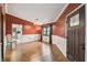 Bright living room with wainscoting, hardwood floors, and large windows overlooking the yard at 194 Heron Bay Cir, Lake Mary, FL 32746