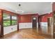 Bright living room with wainscoting, hardwood floors, and a modern light fixture at 194 Heron Bay Cir, Lake Mary, FL 32746