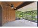 Covered and screened patio featuring an overhead fan and outdoor seating with a view of the backyard at 194 Heron Bay Cir, Lake Mary, FL 32746