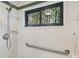 Shower with white tile surround, grab bar, and showerhead on the wall at 194 Heron Bay Cir, Lake Mary, FL 32746