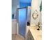 Bathroom featuring modern vanity with decorative fixtures and a glass-enclosed shower at 19430 Sw 100Th Loop, Dunnellon, FL 34432