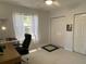 Bright bedroom featuring ample closet space and a large window for natural light at 19430 Sw 100Th Loop, Dunnellon, FL 34432