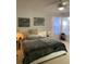 Comfortable bedroom featuring a queen-size bed with cozy bedding, soft lighting, and decorative wall art at 19430 Sw 100Th Loop, Dunnellon, FL 34432