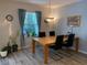 Inviting dining room with a chandelier and natural light from the large window at 19430 Sw 100Th Loop, Dunnellon, FL 34432