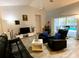 Inviting living room with wood floors, comfortable seating, and natural light at 19430 Sw 100Th Loop, Dunnellon, FL 34432