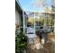Outdoor patio space with a grill, overlooking a screened pool and lush backyard at 19430 Sw 100Th Loop, Dunnellon, FL 34432