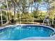 Enclosed pool area showcasing clear blue water and comfortable seating for leisure at 19430 Sw 100Th Loop, Dunnellon, FL 34432
