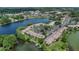Expansive aerial view of lakeside condos, showcasing lush greenery, waterfront scenery, and parking at 200 Maitland Ave # 153, Altamonte Springs, FL 32701
