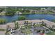 Stunning aerial view of condos nestled by a serene lake, highlighting lush landscaping and parking at 200 Maitland Ave # 153, Altamonte Springs, FL 32701
