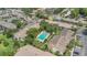 Aerial view of condos with a pool, mature trees, lawns and parking. The buildings have light exteriors at 200 Maitland Ave # 153, Altamonte Springs, FL 32701