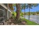 Picturesque backyard by the water with tall trees providing shade and a glimpse of the lake beyond at 200 Maitland Ave # 153, Altamonte Springs, FL 32701