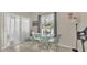 A dining area features a glass table, chairs, a stained glass window, and sliding door access at 200 Maitland Ave # 153, Altamonte Springs, FL 32701