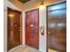 Neutral colored hallway with three dark brown doors with access to multiple units on the floor at 200 Maitland Ave # 153, Altamonte Springs, FL 32701