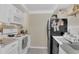 Efficient kitchen featuring a white oven, black refrigerator, and crisp white cabinetry at 200 Maitland Ave # 153, Altamonte Springs, FL 32701