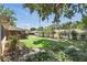 Spacious backyard featuring a white fence, mature trees, and lush landscaping, creating a private outdoor space at 2024 Linden Road, Winter Park, FL 32792