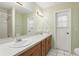 Bathroom with dual sinks, mirror, and tiled flooring at 2024 Linden Road, Winter Park, FL 32792