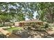 Beautiful home exterior with a brick facade, mature trees, and a well-maintained front yard creating a serene setting at 2024 Linden Road, Winter Park, FL 32792