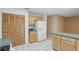 Kitchen featuring light wood cabinets, white appliances, and tile flooring at 2024 Linden Road, Winter Park, FL 32792