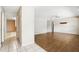 Bright open-concept living space with wood floors, tiled foyer, and closet offering ample storage and seamless transitions at 2024 Linden Road, Winter Park, FL 32792