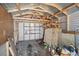 View of shed interior with exposed wood framing and plywood walls with storage shelves at 2024 Linden Road, Winter Park, FL 32792