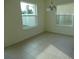 Dining room with tile floors, two windows, chandelier and neutral paint at 2737 Monticello Way, Kissimmee, FL 34741