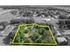A serene aerial view of a property line and home, featuring lush landscaping and surrounding trees at 2810 Windsong Ln, St Cloud, FL 34772
