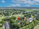 A serene aerial view of a community, featuring lush landscaping and surrounding trees with pin drop at 2810 Windsong Ln, St Cloud, FL 34772