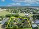 A serene aerial view of a property line and home, featuring lush landscaping and surrounding trees at 2810 Windsong Ln, St Cloud, FL 34772