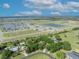 A serene aerial view of a Primary-planned community, featuring lush landscaping and a tranquil lake at 2810 Windsong Ln, St Cloud, FL 34772