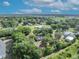 A serene aerial view of a community, featuring lush landscaping and surrounding trees at 2810 Windsong Ln, St Cloud, FL 34772