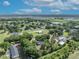 A serene aerial view of a community, featuring lush landscaping and surrounding trees at 2810 Windsong Ln, St Cloud, FL 34772