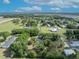 A serene aerial view of a community, featuring lush landscaping and surrounding trees at 2810 Windsong Ln, St Cloud, FL 34772