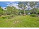 Serene backyard with plenty of green space, perfect for recreation and relaxation at 2810 Windsong Ln, St Cloud, FL 34772