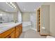 Bright bathroom featuring double sinks, a soaking tub, glass shower, and ample storage at 2810 Windsong Ln, St Cloud, FL 34772
