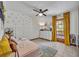 Inviting bedroom with stylish accents, decorative wallpaper, and an outdoor view at 2810 Windsong Ln, St Cloud, FL 34772