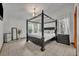 Spacious bedroom featuring a stylish canopy bed, tile flooring, and bright natural light at 2810 Windsong Ln, St Cloud, FL 34772