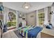 bedroom featuring large windows, a compass ceiling accent, and unique decor at 2810 Windsong Ln, St Cloud, FL 34772