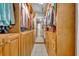 Spacious walk-in closet with custom wood shelving, drawers, and ample storage at 2810 Windsong Ln, St Cloud, FL 34772