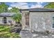 Inviting entrance of the home featuring a solid wood door and manicured landscape at 2810 Windsong Ln, St Cloud, FL 34772