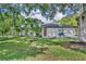 Charming single-story brick home with lush front yard and mature trees, offering a serene setting at 2810 Windsong Ln, St Cloud, FL 34772