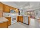 Bright kitchen with wood cabinets, tile floors, stainless steel appliances, and French doors at 2810 Windsong Ln, St Cloud, FL 34772
