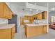 Kitchen with wood cabinets, stainless steel refrigerator, and tile floors at 2810 Windsong Ln, St Cloud, FL 34772