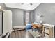 This gray bedroom features laminate wood floors, a desk, and bench seating at 2848 Wilshire Rd, Clermont, FL 34714