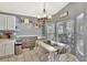 Cozy dining area with natural light, white table set, and stylish decor at 2848 Wilshire Rd, Clermont, FL 34714