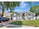 Inviting home exterior featuring a well-maintained lawn, arched windows, and a two-car garage at 2848 Wilshire Rd, Clermont, FL 34714