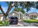 Inviting home exterior featuring a well-maintained lawn, arched windows, and a two-car garage at 2848 Wilshire Rd, Clermont, FL 34714