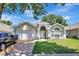 Inviting home exterior featuring a well-maintained lawn, arched windows, and a two-car garage at 2848 Wilshire Rd, Clermont, FL 34714