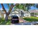 Exterior of home featuring well maintained lawn, established trees, and private driveway at 2848 Wilshire Rd, Clermont, FL 34714