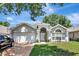 Charming single-Gathering home showcasing a well-maintained lawn and a two-car garage at 2848 Wilshire Rd, Clermont, FL 34714