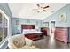 A comfortable main bedroom boasts a decorative chair and doorway that leads to the bathroom at 2848 Wilshire Rd, Clermont, FL 34714